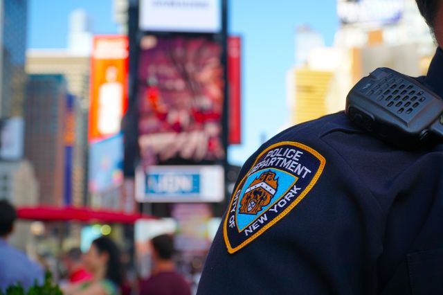 A closeup of an NYPD patch on an officer's shirt